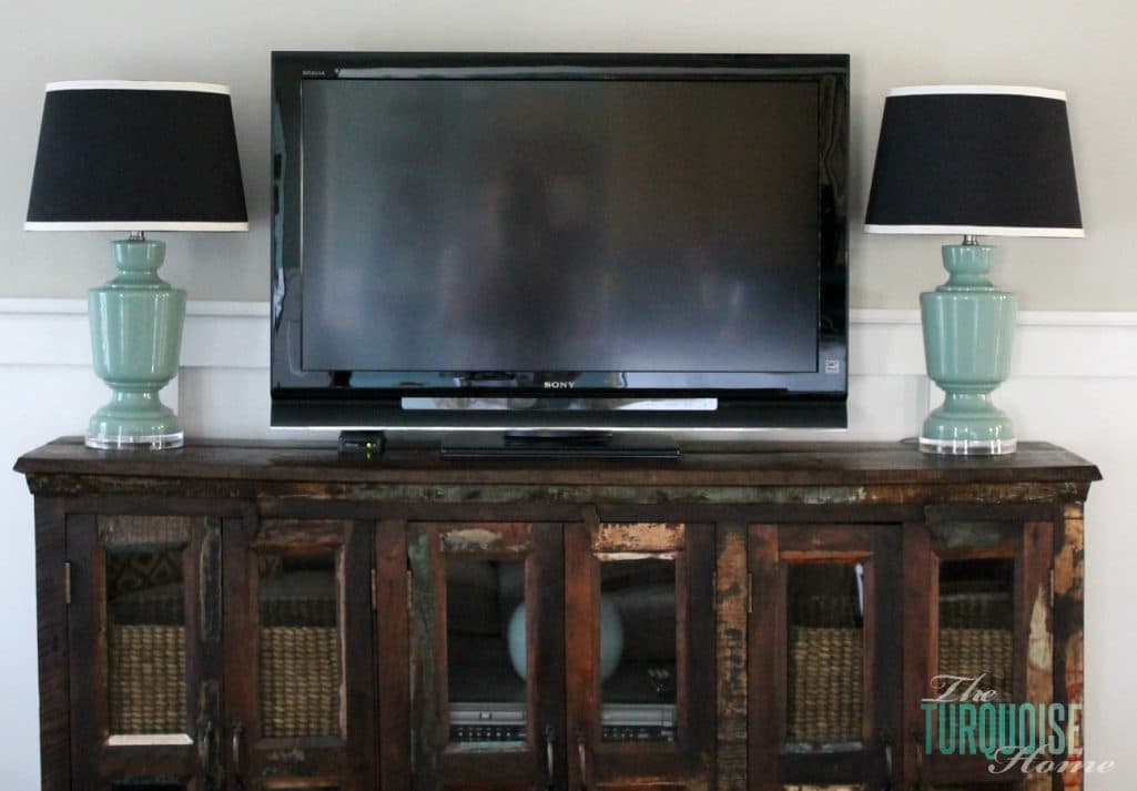 blue glass lamps on media console