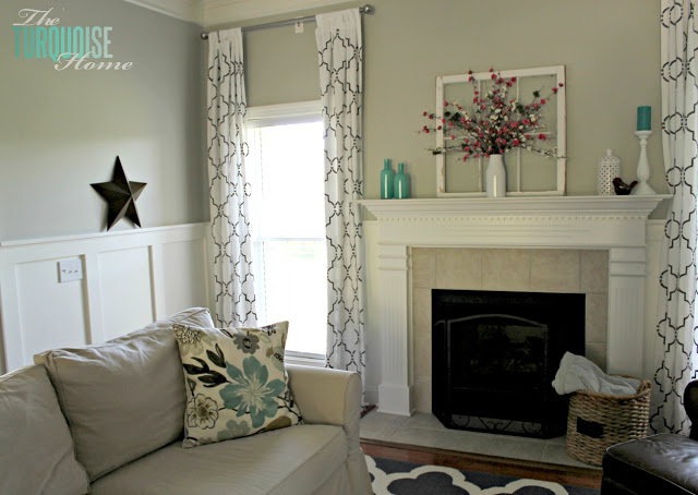 Gorgeous Living Room Makeover with beautiful DIY board and batten, Pottery Barn sofa, stenciled curtains, warm wood and pops of turquoise!