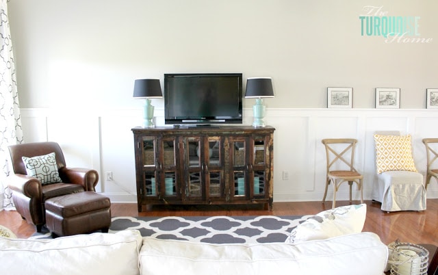 Gorgeous Living Room Makeover with beautiful DIY board and batten, Pottery Barn sofa, stenciled curtains, warm wood and pops of turquoise!