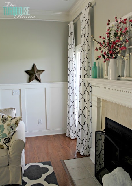 Gorgeous Living Room Makeover with beautiful DIY board and batten, Pottery Barn sofa, stenciled curtains, warm wood and pops of turquoise!