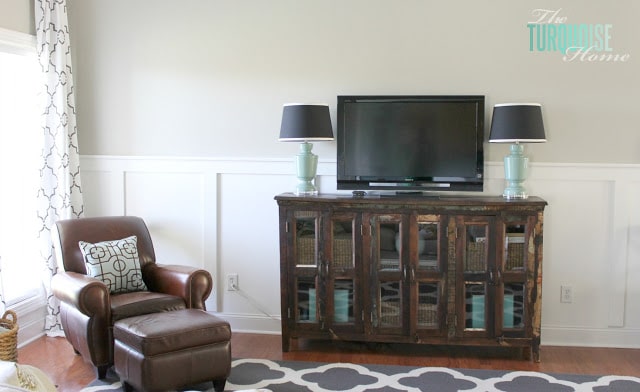 Gorgeous Living Room Makeover with beautiful DIY board and batten, Pottery Barn sofa, stenciled curtains, warm wood and pops of turquoise!
