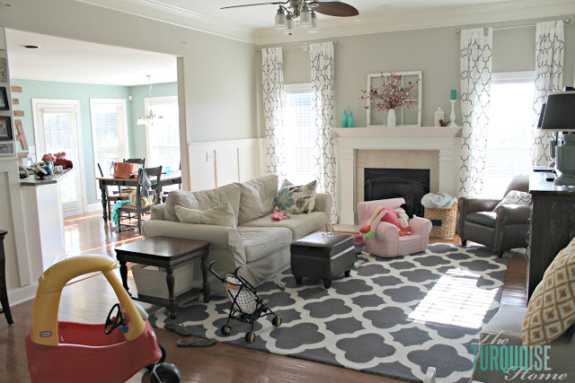 Gorgeous Living Room Makeover with beautiful DIY board and batten, Pottery Barn sofa, stenciled curtains, warm wood and pops of turquoise!