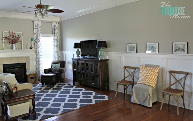Gorgeous Living Room Makeover with beautiful DIY board and batten, Pottery Barn sofa, stenciled curtains, warm wood and pops of turquoise!