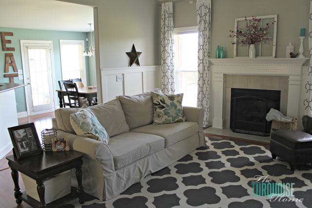 Gorgeous Living Room Makeover with beautiful DIY board and batten, Pottery Barn sofa, stenciled curtains, warm wood and pops of turquoise!