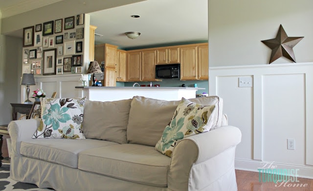 Gorgeous Living Room Makeover with beautiful DIY board and batten, Pottery Barn sofa, stenciled curtains, warm wood and pops of turquoise!