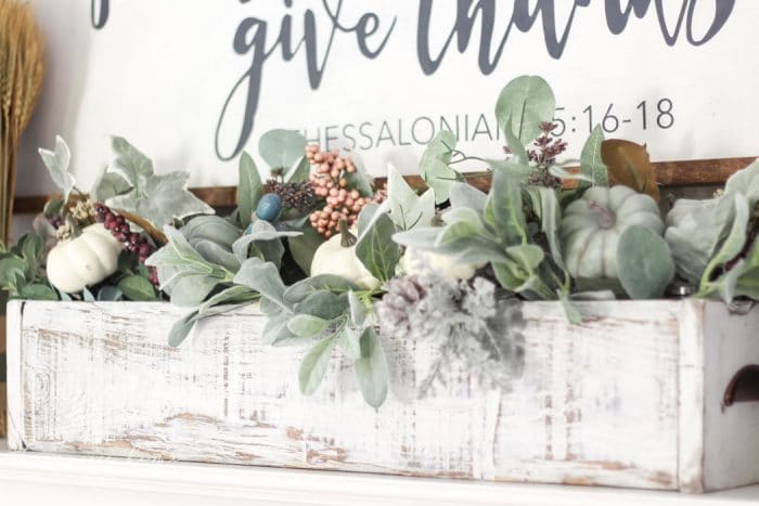 Adorable faux foliage centerpiece made with a wooden box, mason jars and faux stems. LOVE!