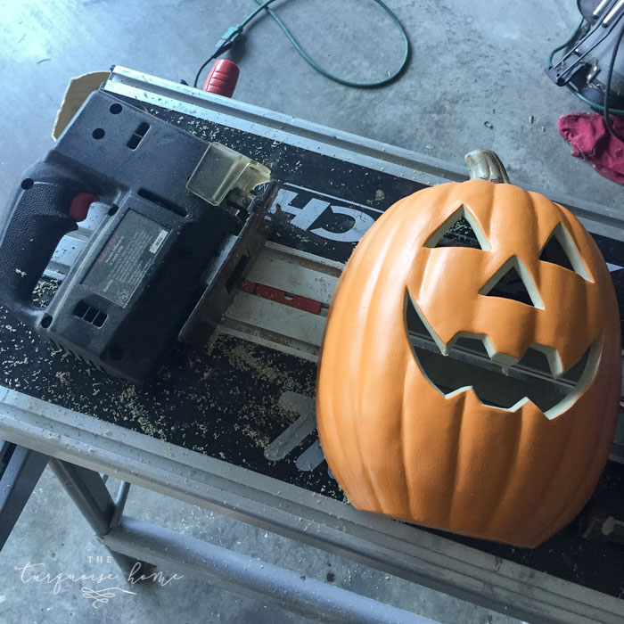 Cut the pumpkin in half for the DIY Lighted Pumpkin Candy Holder