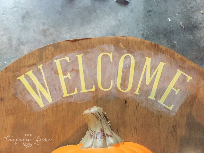 Use vinyl letters to create a welcoming message for your DIY Lighted Pumpkin Candy Holder.