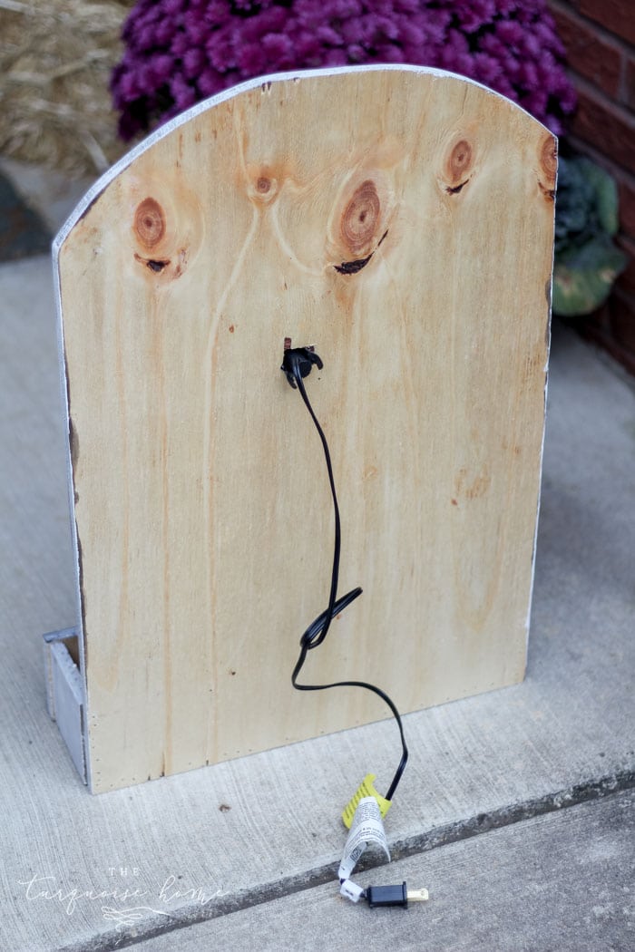 Attach the light to the hole in the back of the board for your lighted pumpkin candy holder! Plug it in and voila - the cutest jack-o-lantern candy holder you've ever seen!