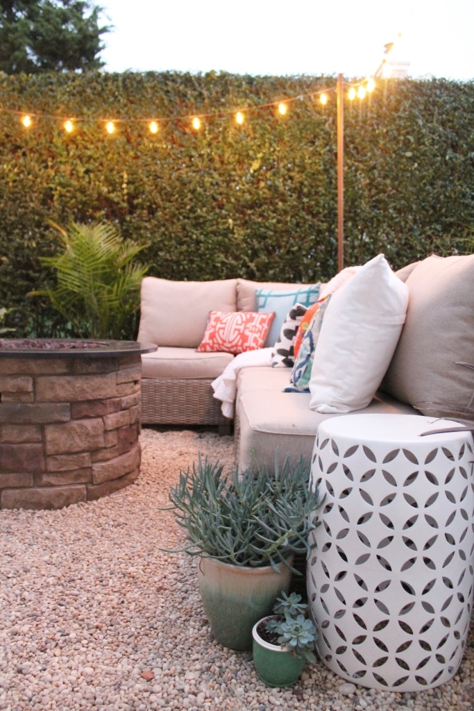 Dreamy Hamptons Backyard Barbecue with sofa and string lights.