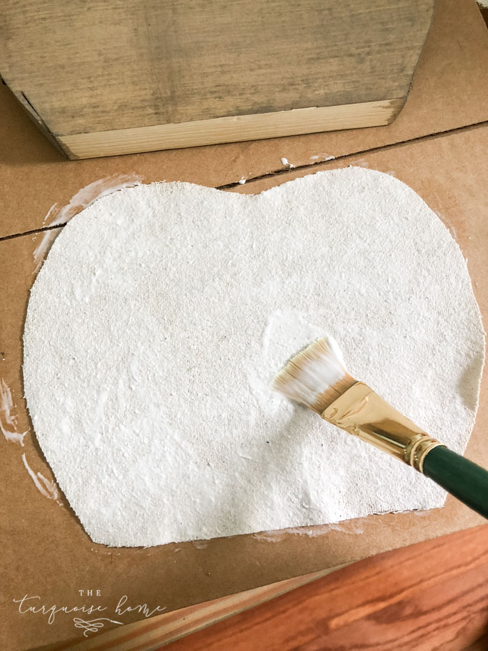 Use Mod Podge to glue the drop cloth to the pumpkin.