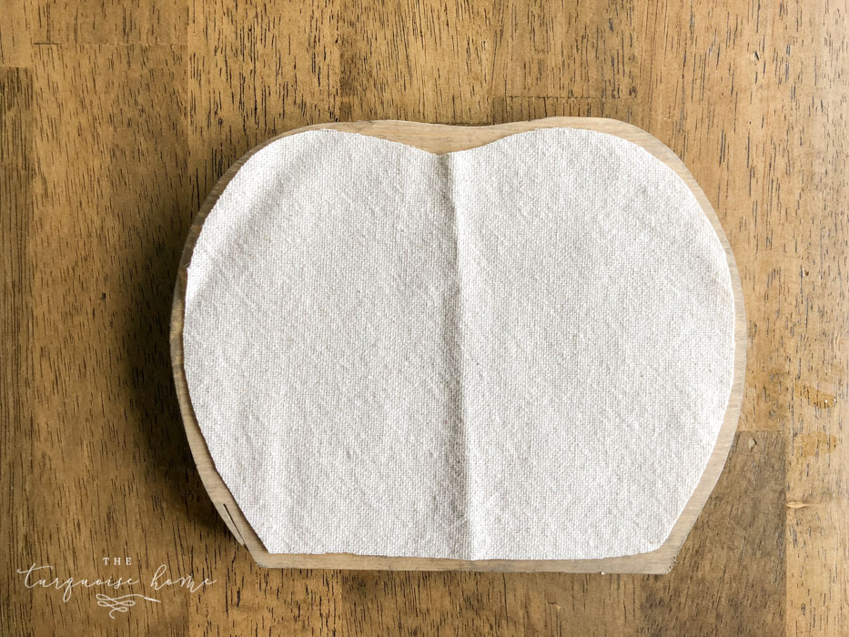 Use Mod Podge to glue the drop cloth to the pumpkin.