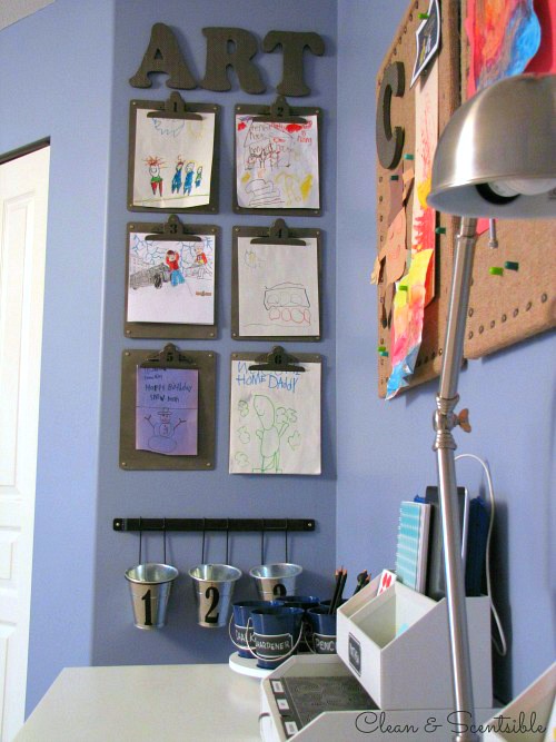 organized homework space with clipboard art on the walls.