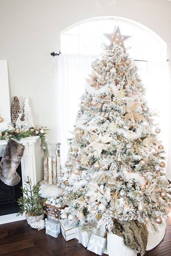 flocked Christmas tree with gold and silver ornaments.