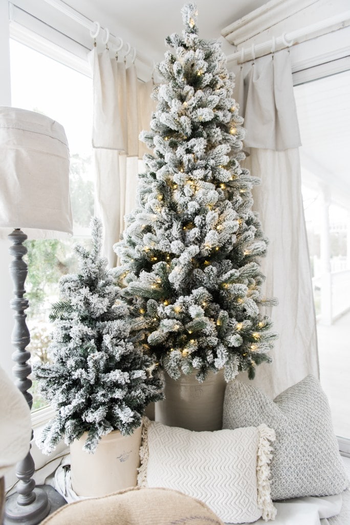 two simple flocked Christmas trees in crocks.