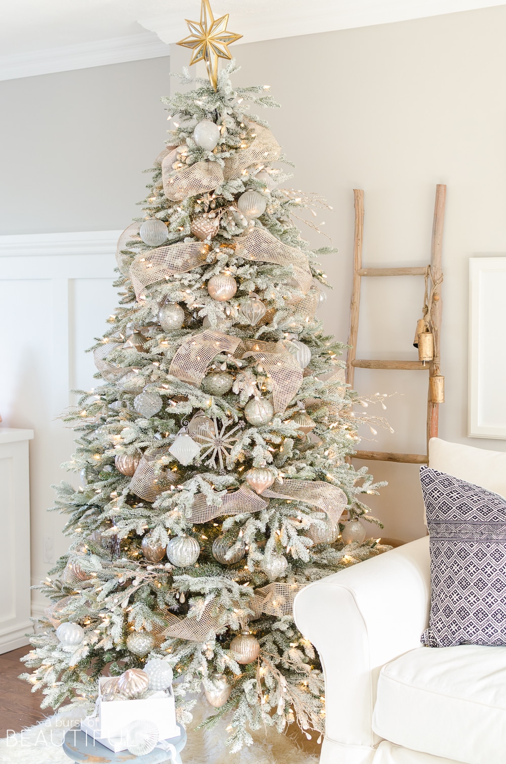 neutral flocked Christmas tree with blush, gold and silver ornaments.