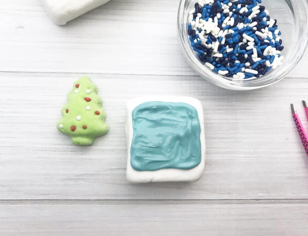 Pour the blue candy on the marshmallow.