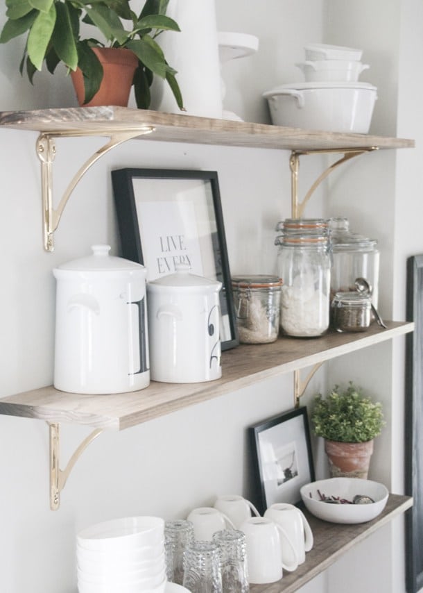brass hardware and light stain on open shelves.
