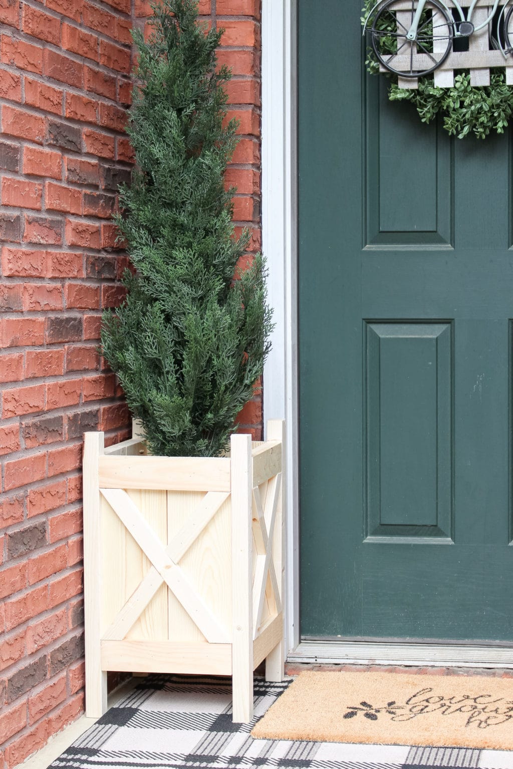 Completed DIY wood planter box on front porch