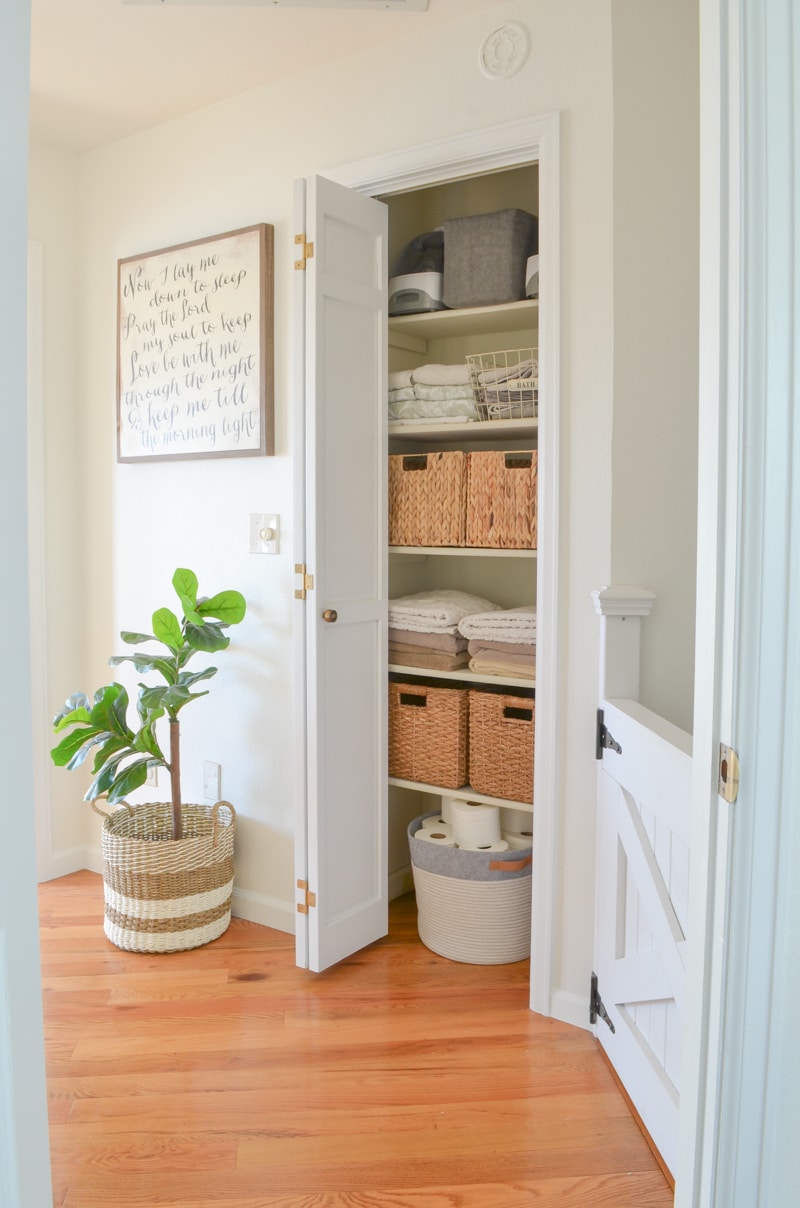 This gorgeous linen closet from Sarah Joy Blog is the perfect combination of storage bins and folded towels with a beautiful bin for corralling toilet paper.