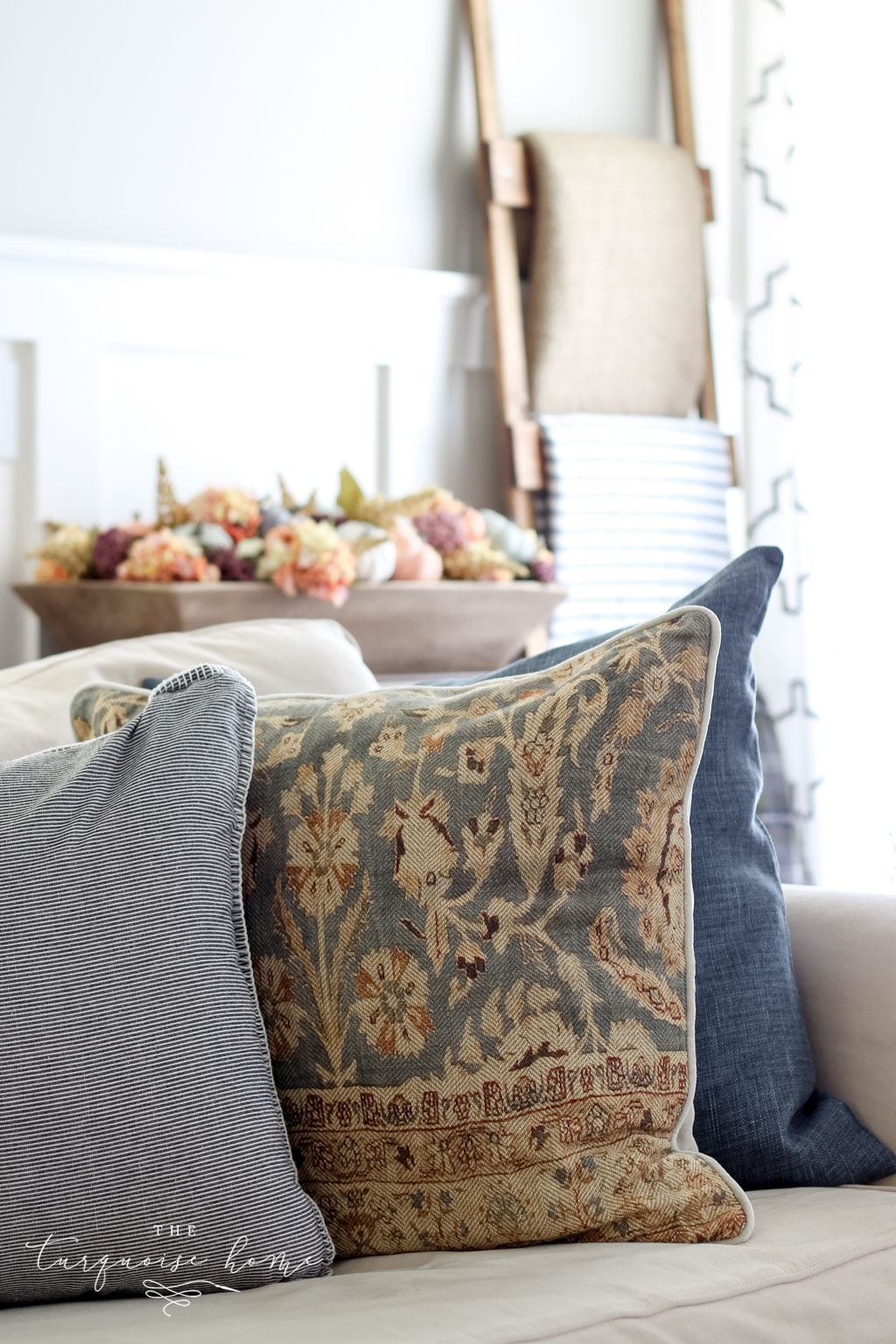 Neutral fall decor with some small pops of jewel tones - bring a cozy, yet fun vibe to this fall living room decor.