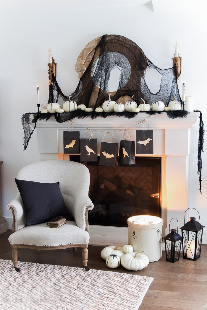Classic black and white touches make this Halloween mantel decor super affordable and easy to achieve!