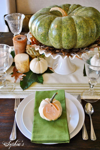 elevated pumpkin in the center of a thanksgiving tablescape