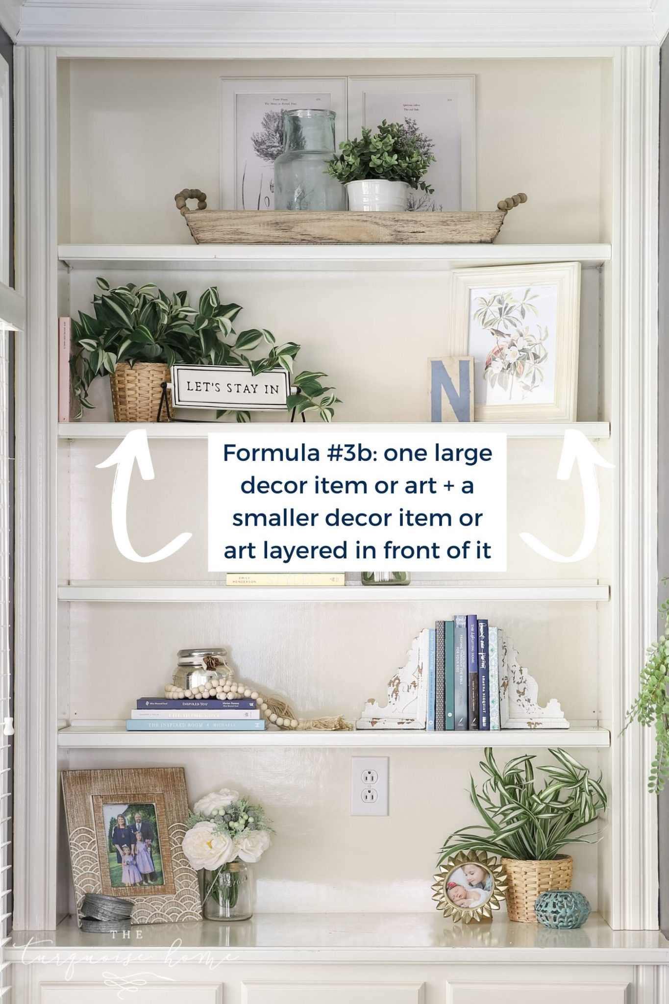 White built-in bookshelves with greenery, art and books!