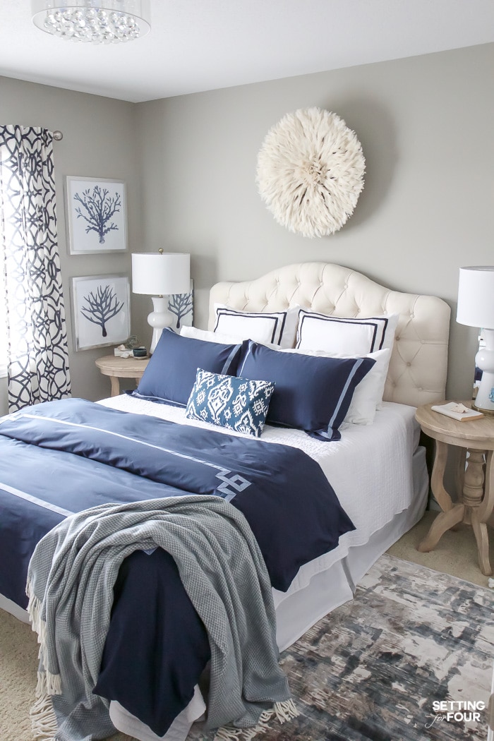 a juju hat hangs on the wall above a bed