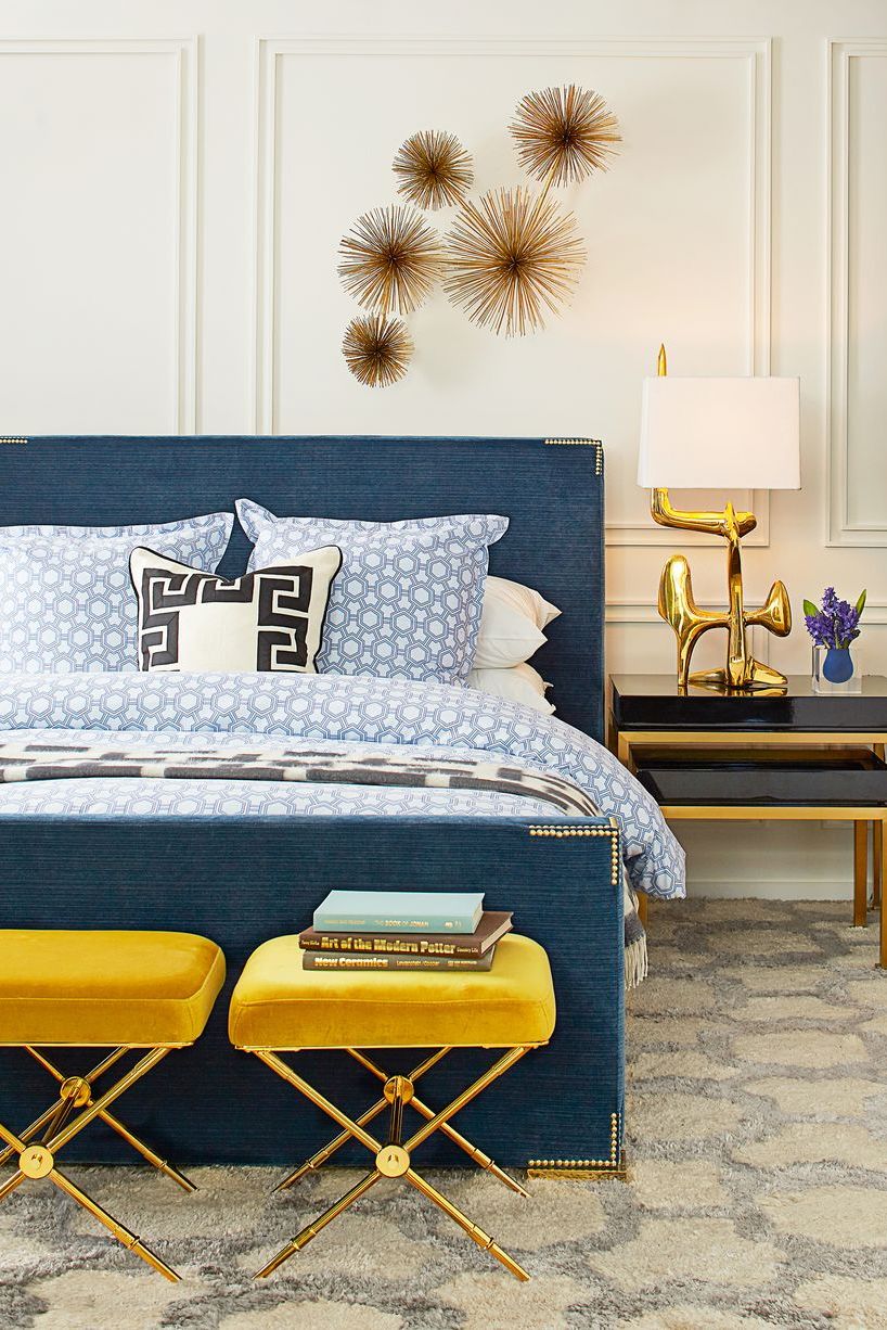 Brass urchins are arranged and hang above a bed in a bedroom