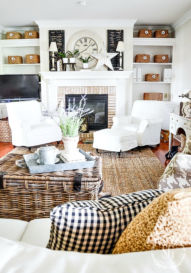neutral farmhouse mantel decor with white start and orchid greenery