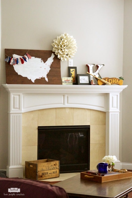 summer fireplace decor with map and travel souvenirs