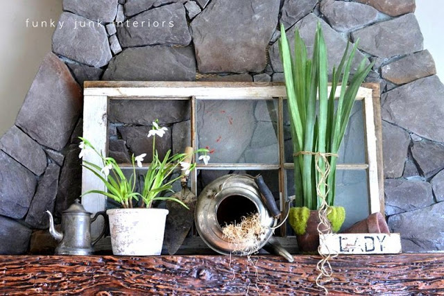 a collection of antique pieces mixed with fresh greenery for springtime mantel decor