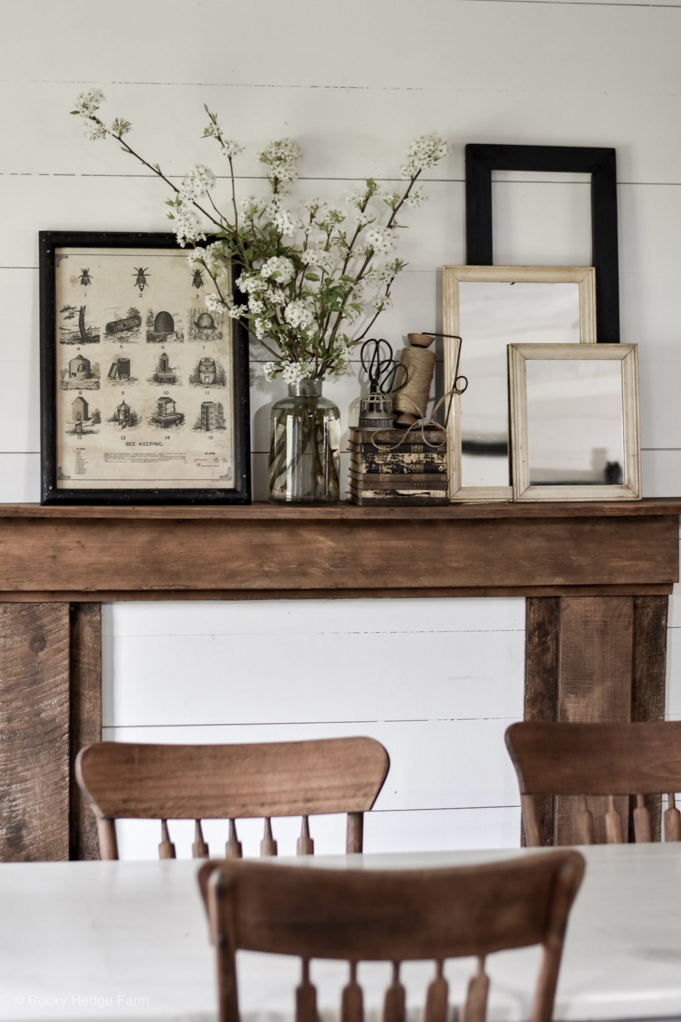 Vintage fireplace mantel decorations with layered mirrors and other vintage pieces