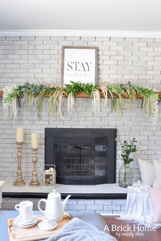 spring fireplace mantel with cascading greenery