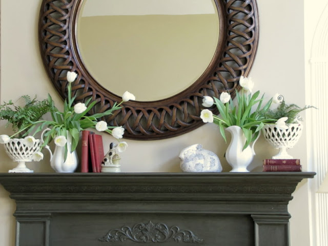 spring mantel design with circle mirror, white tulips and bunnies