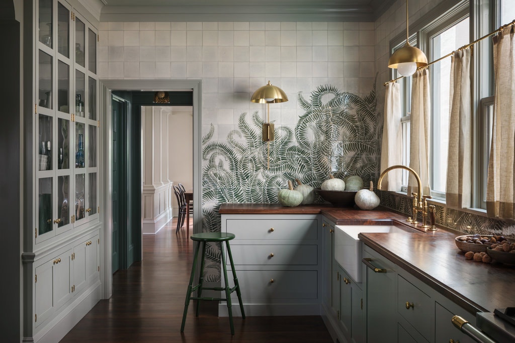 Storm Cloud Gray is a beautiful medium green paint shade that looks stunning on the cabinetry and trim in this moody kitchen.