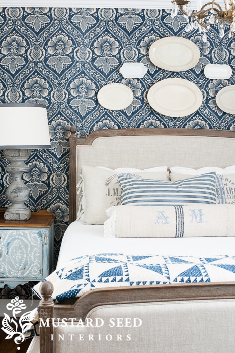 hanging platters and plates above bed