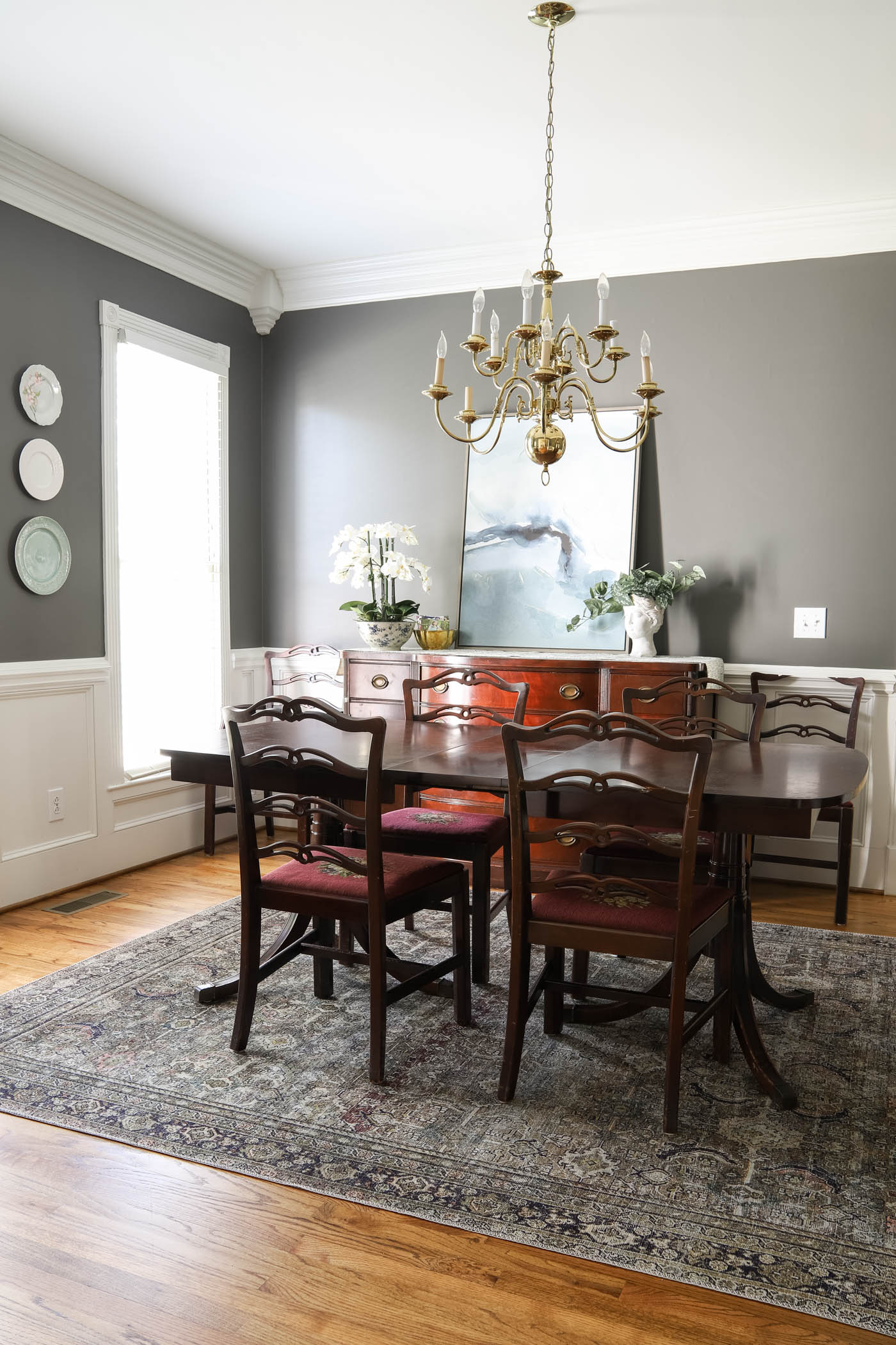 dining room before with charcoal walls and antique furniture.