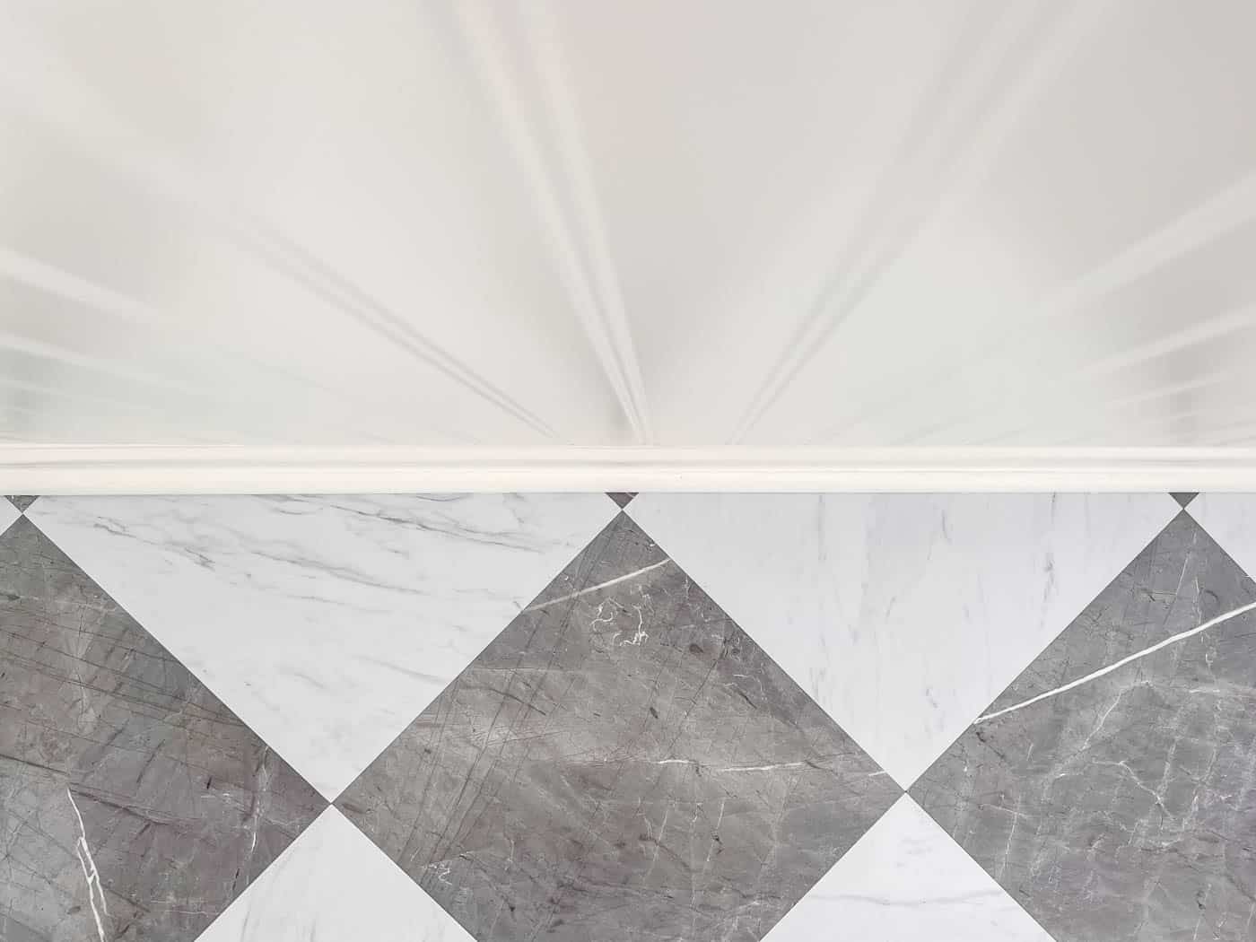 row of checkerboard vinyl floor tiles