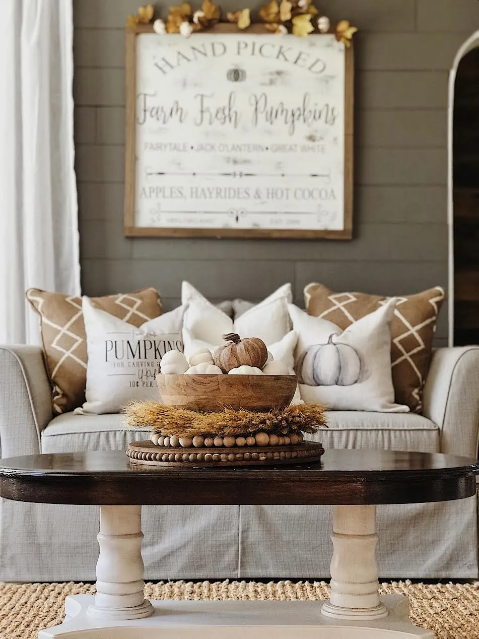 fall centerpiece with pumpkins on a coffee table