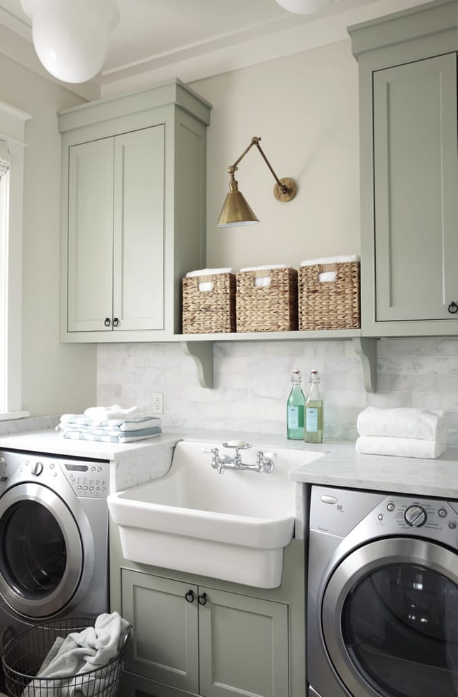 Laundry room with upper and lower cabinets painted in Oyster Bay by Sherwin Williams