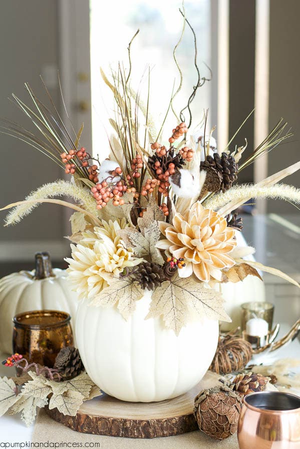white pumpkin acting as a vase with a floral display inside