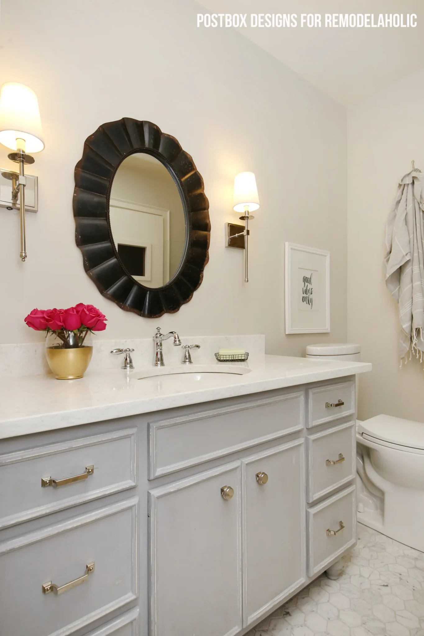 bathroom with BM Balboa Mist walls and gray vanity