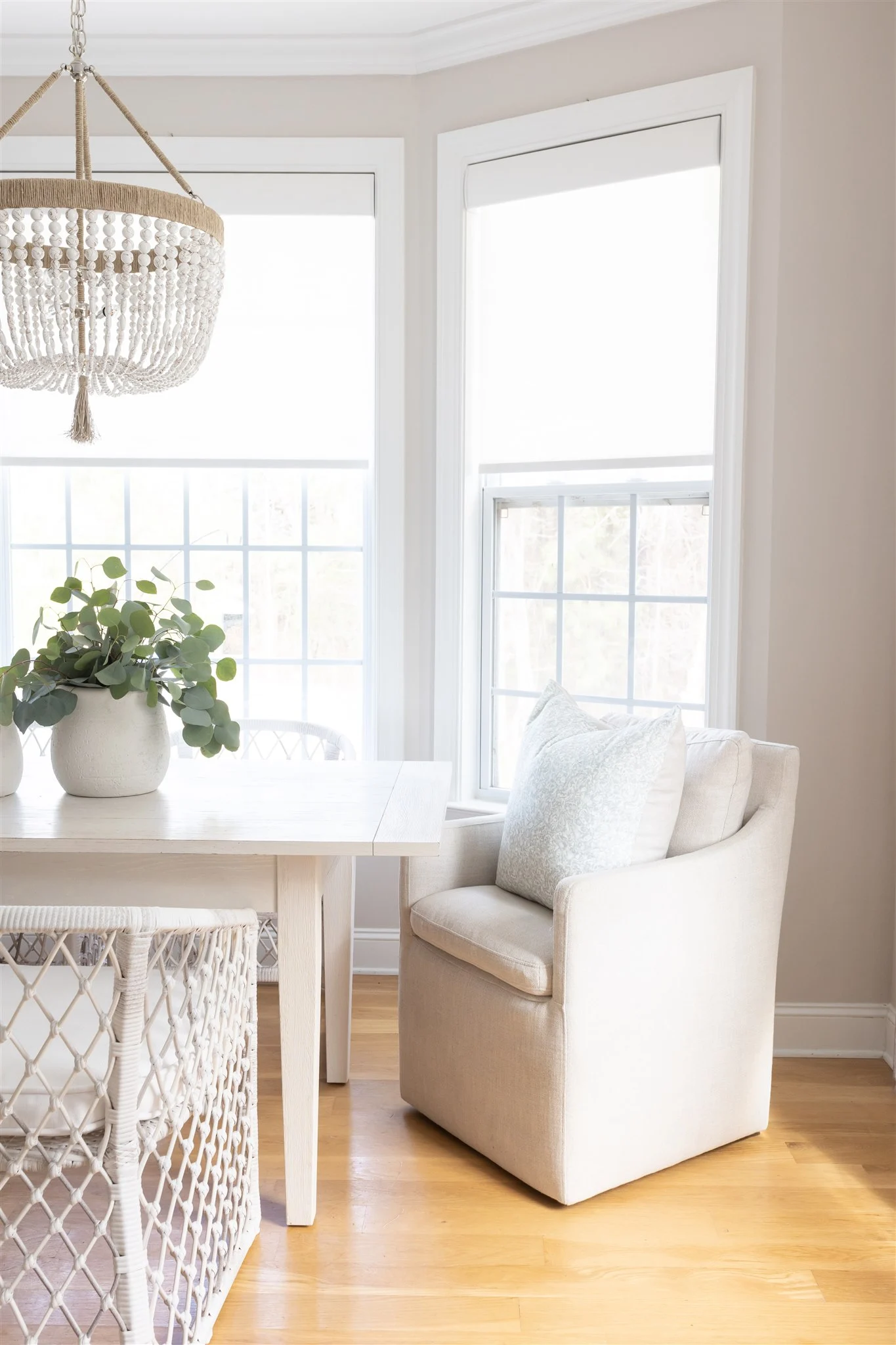dining room with balboa mist walls, white trim, farmhouse decor and a chandelier