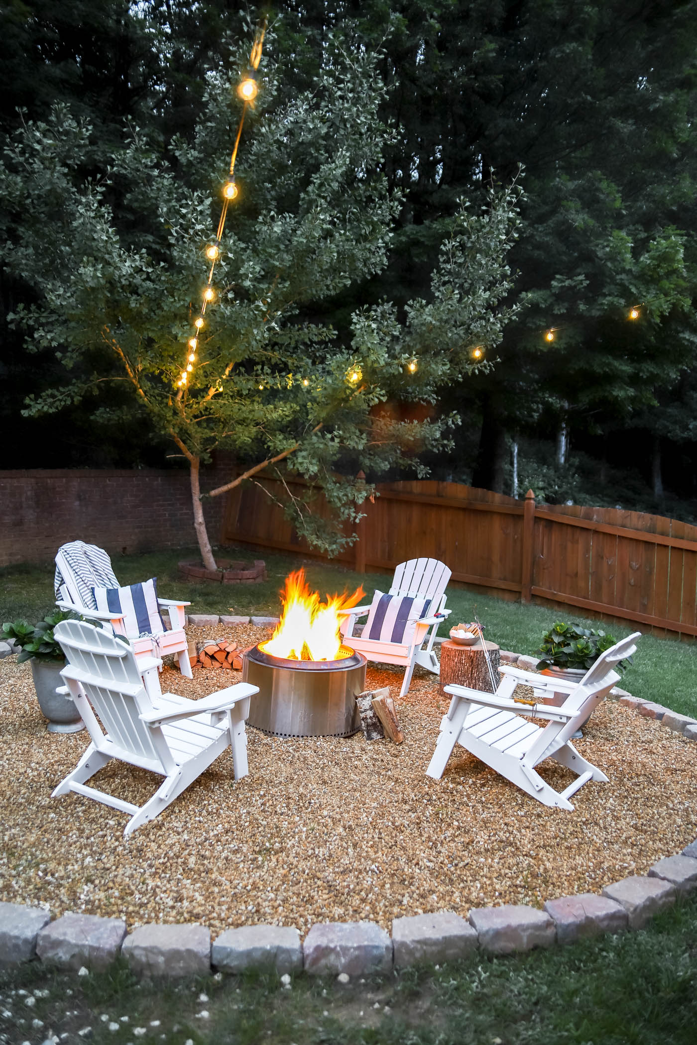 white Adirondack chairs and outdoor fire pit area with solo stove