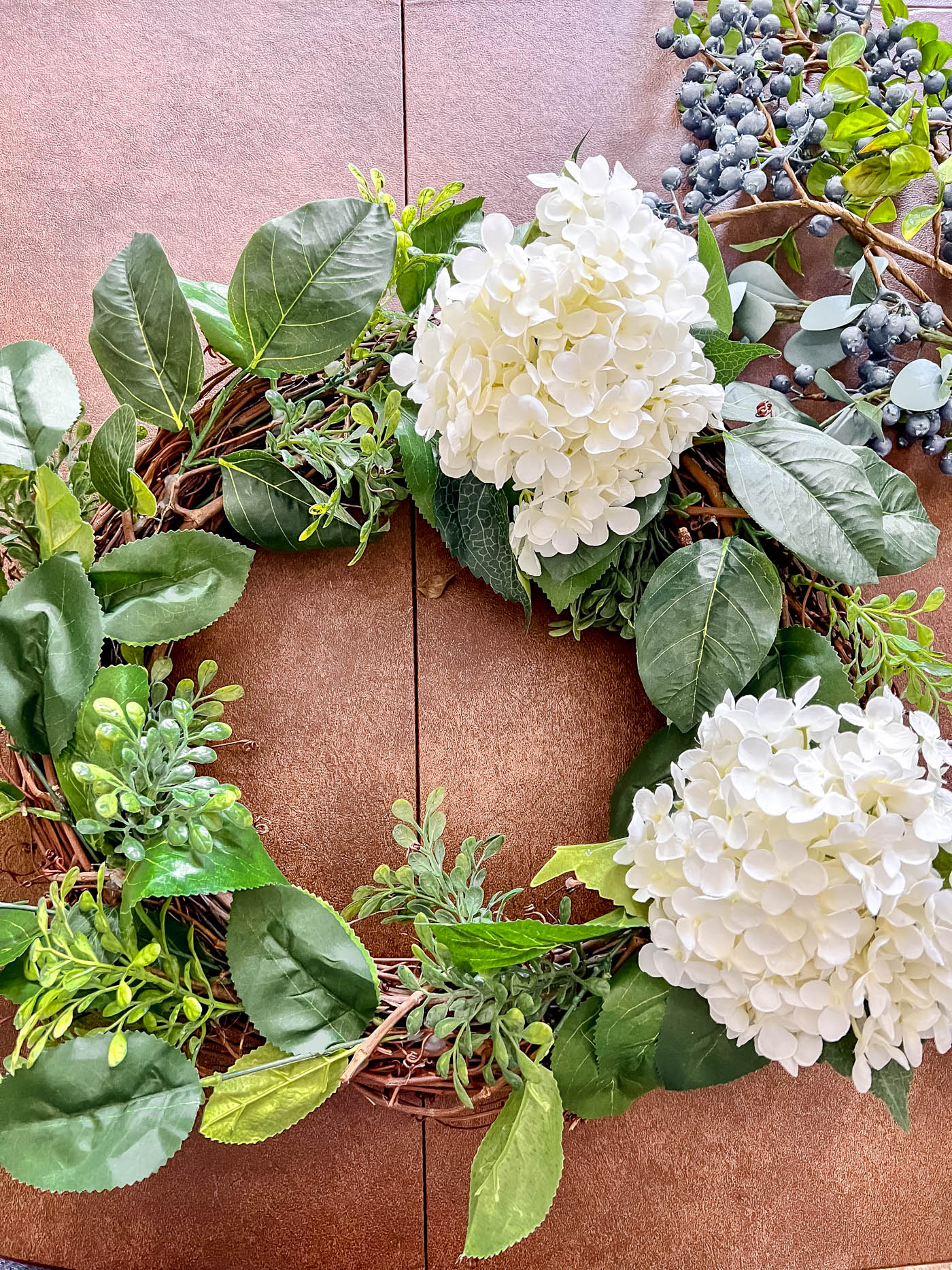 Add hydrangeas to patriotic wreath