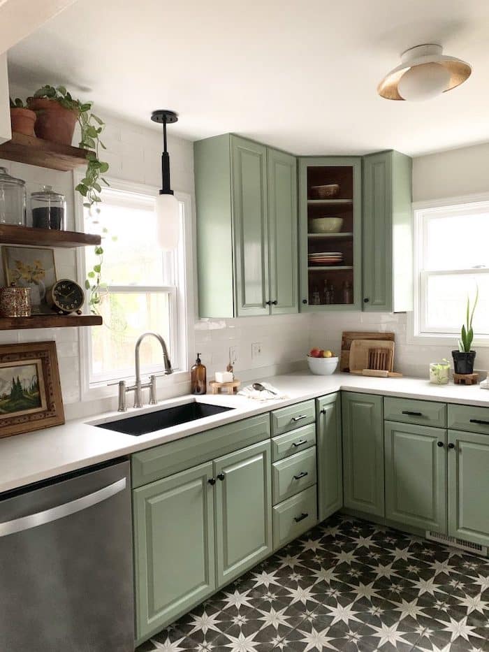 kitchen with white subway tiles and Behr Bitter Sage painted cabinets.