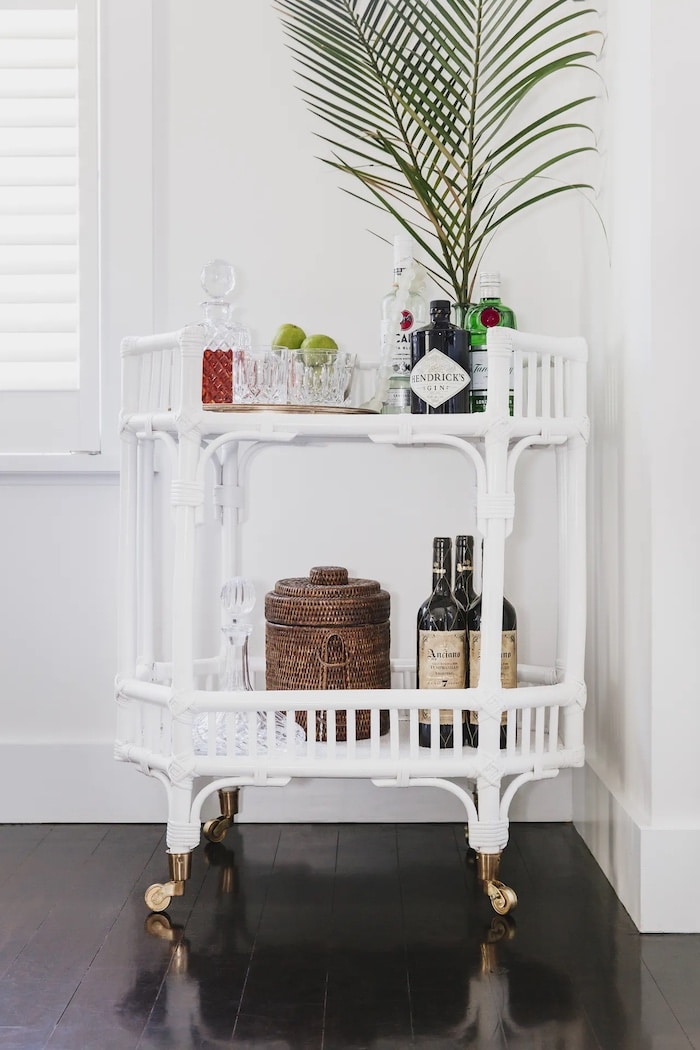 bar cart in the corner of a dining room.