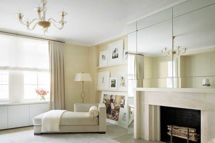 chaise lounge and floor lamp in the corner of a yellow living room.